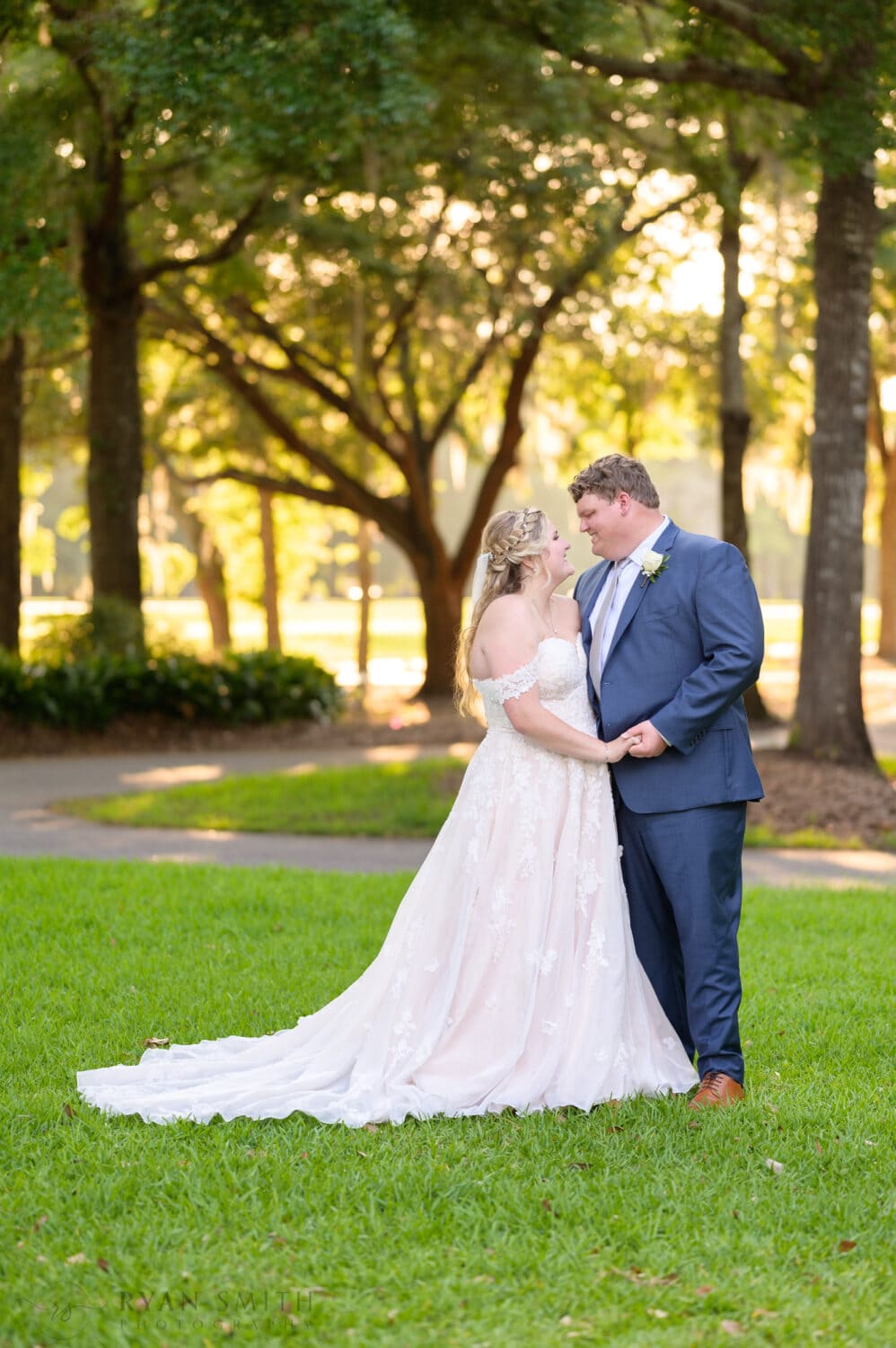 Bride and groom looking into each other eyes in front of the clubhouse - Pawleys Plantation