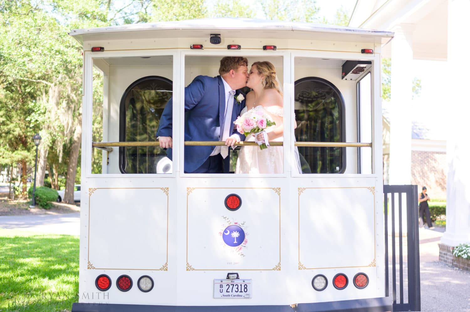 Bride and groom on the back of the trolley  - Pawleys Plantation
