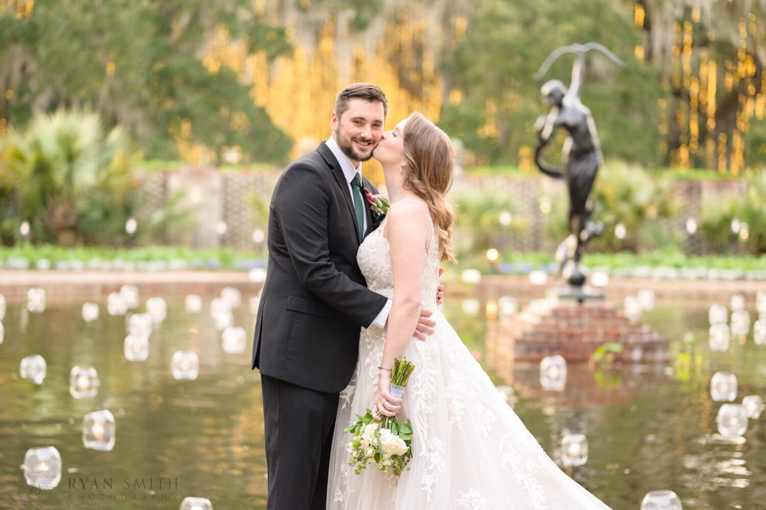 Bride kissing groom on the cheek - Diana of the Chase Fountain - Brookgreen Gardens