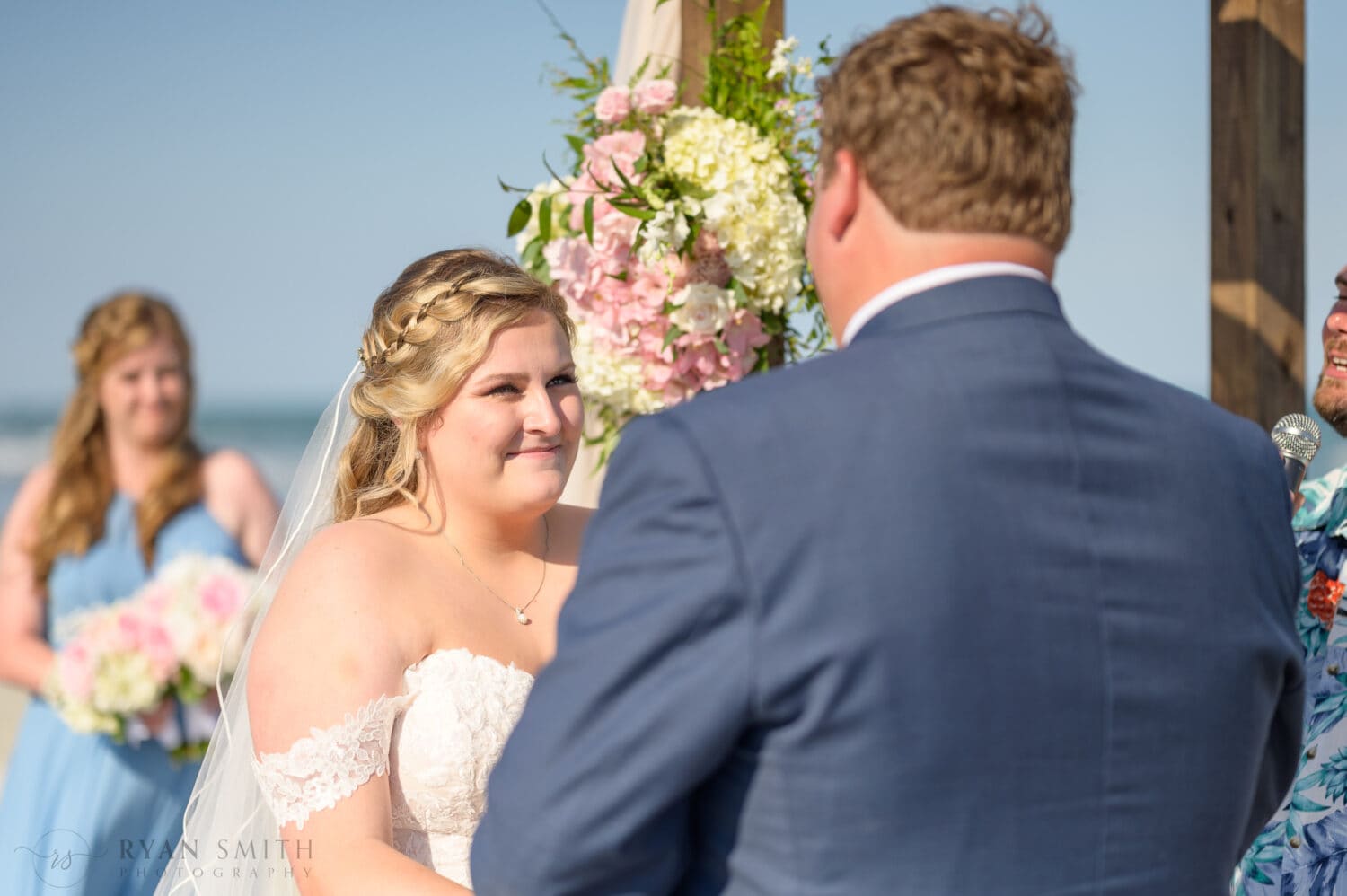 Bride looking into grooms eyes during the ceremony - Pawleys Island Beach House
