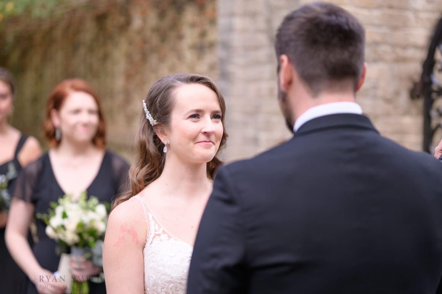 Bride looking into grooms eyes during the vows - Brookgreen Gardens