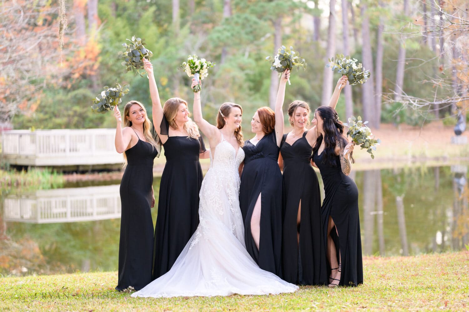 Bridesmaids cheering and holding flowers in the air - Brookgreen Gardens