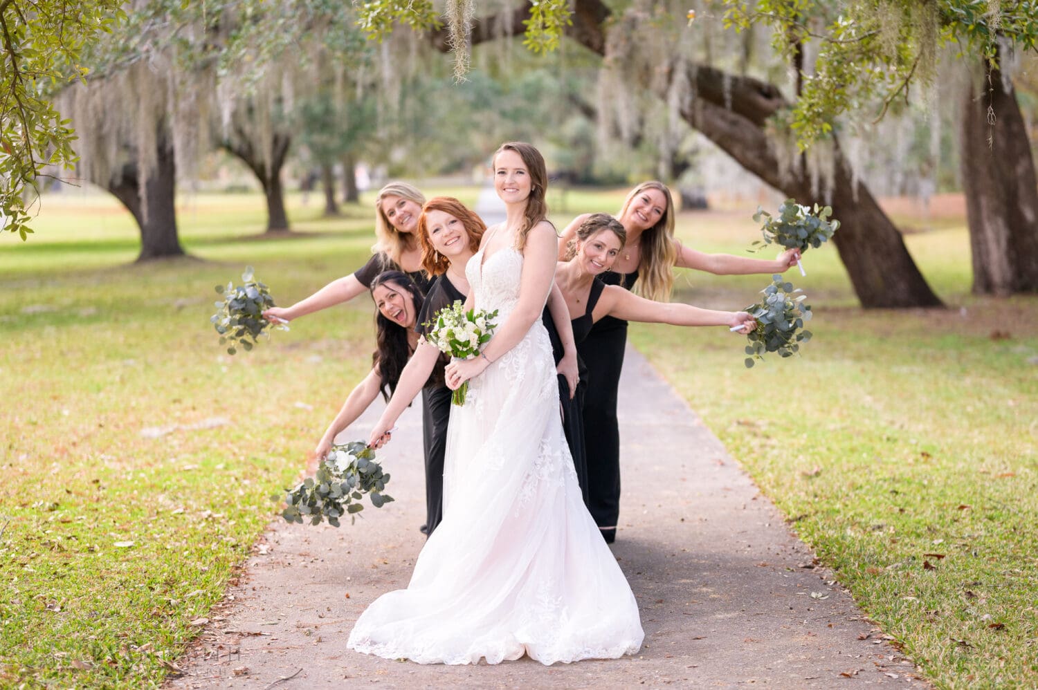 Bridesmaids leaning out from behind the bride - Brookgreen Gardens