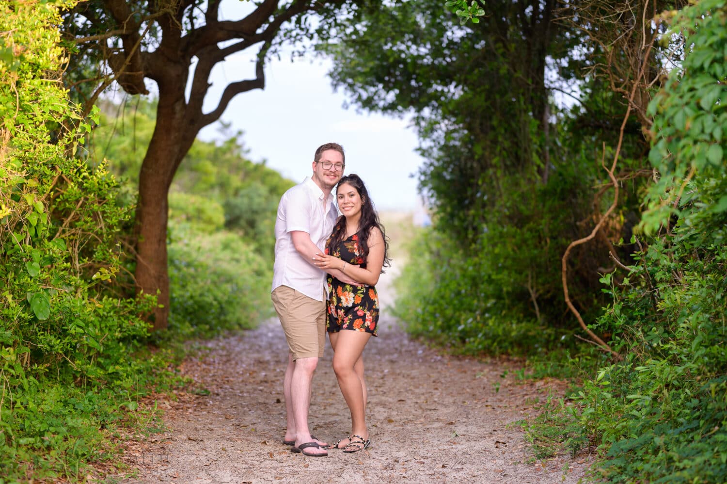 Engagement portrait surrounded by greenery on the beach pathway - Huntington Beach State Park - Myrtle Beach