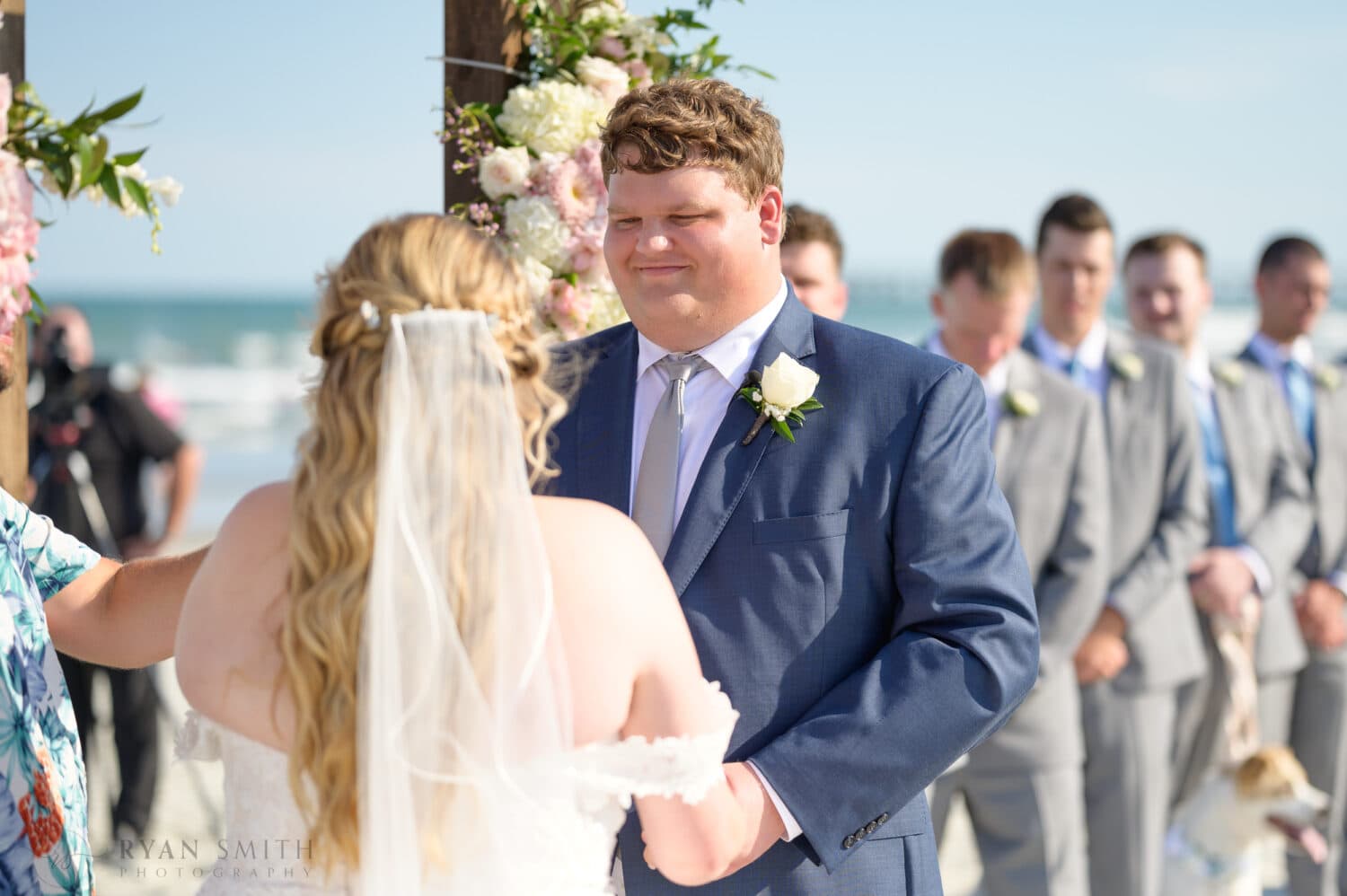 Groom looking into bride's eyes during the vows - Pawleys Island Beach House