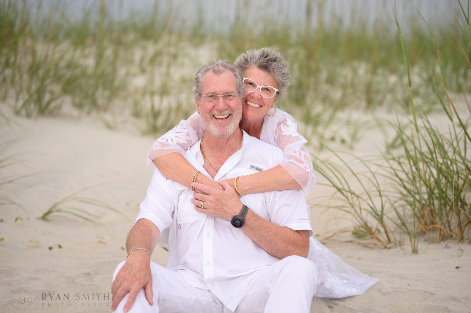Happy older couple with big smiles by the dunes - Huntington Beach State Park - Myrtle Beach