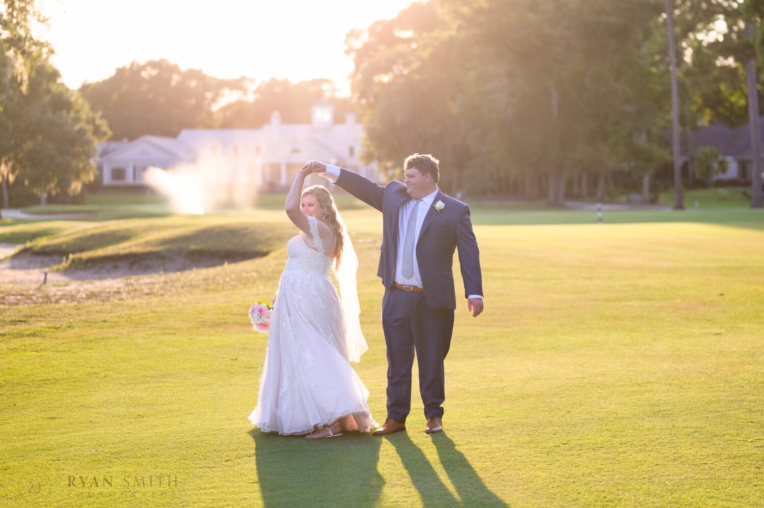 Holding hands walking down the golf course - Pawleys Plantation