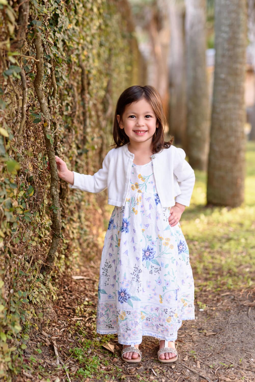Little girl leaning against the ivy wall - Atalaya Castle