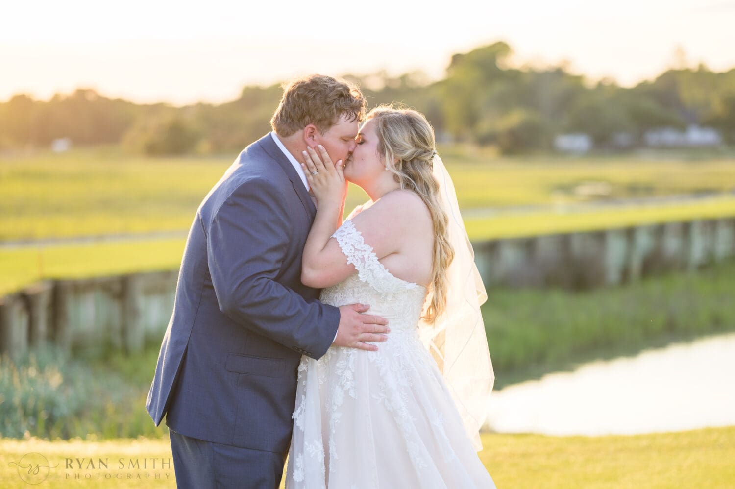 Pulling groom in for a kiss - Pawleys Plantation