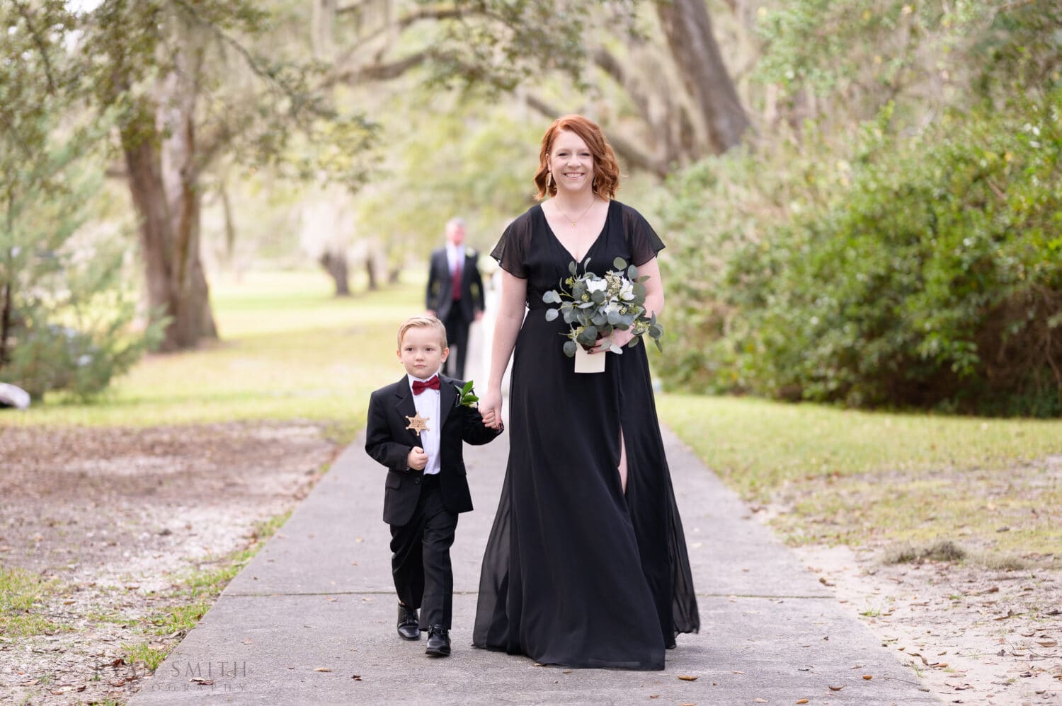 Ring-bearer walking with mom down the aisle  - Brookgreen Gardens