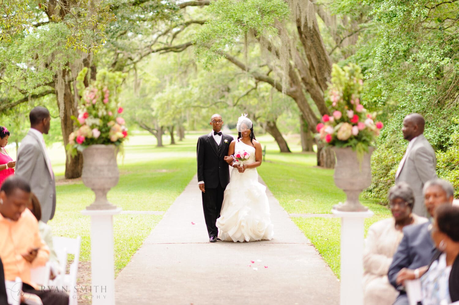 Wedding ceremony by the wrought iron gates on the Oak Allee  - Brookgreen Gardens, Murrells Inlet, SC