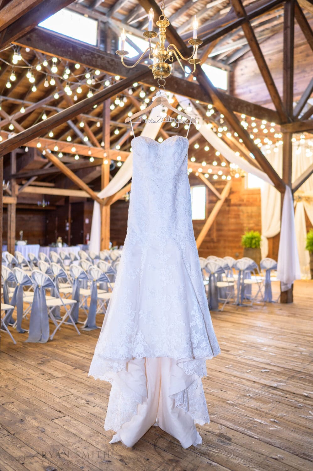 Brides dress hanging with the lights - The Peanut Warehouse - Conway