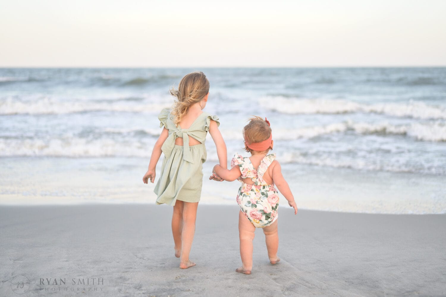 Cute baby sisters by the ocean - Huntington Beach State Park