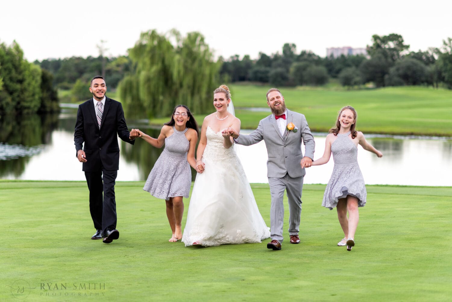Happy new family on the golf course from yesterday's wedding - Grande Dunes Members Club