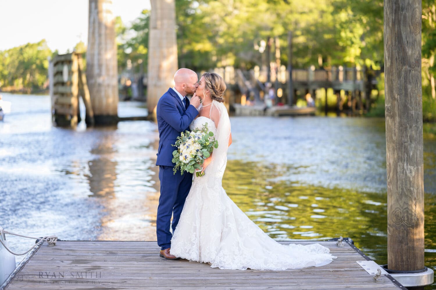 Portraits of the bride and groom on the dock by the river - The Conway Riverwalk