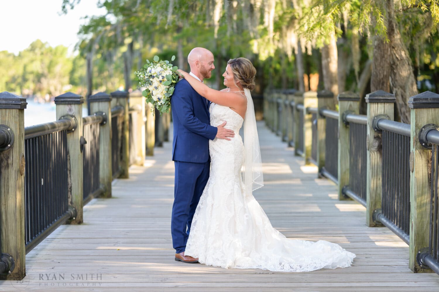 Portraits of the bride and groom under the moss on the Riverwalk - The Conway Riverwalk