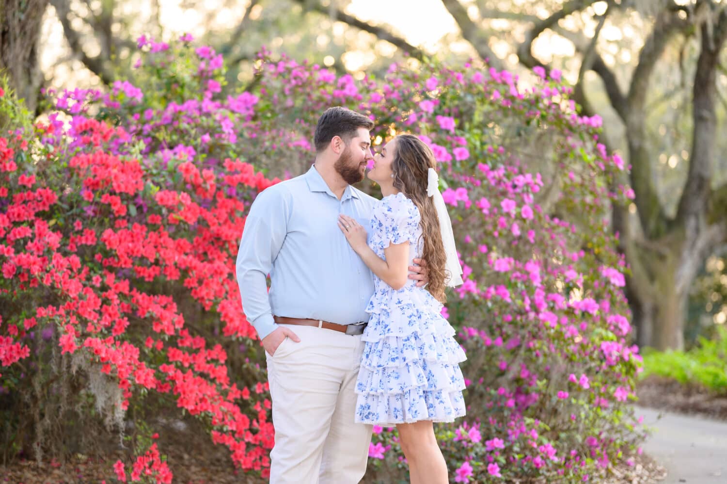 Engagement portraits in front of the red and purple flowers - Caledonia Golf and Fish Club