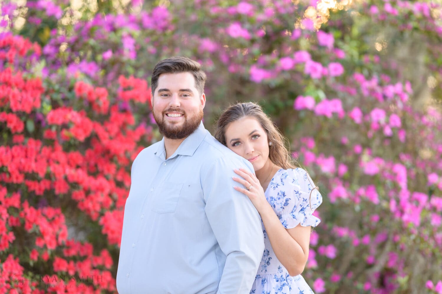 Engagement portraits in front of the red and purple flowers - Caledonia Golf and Fish Club