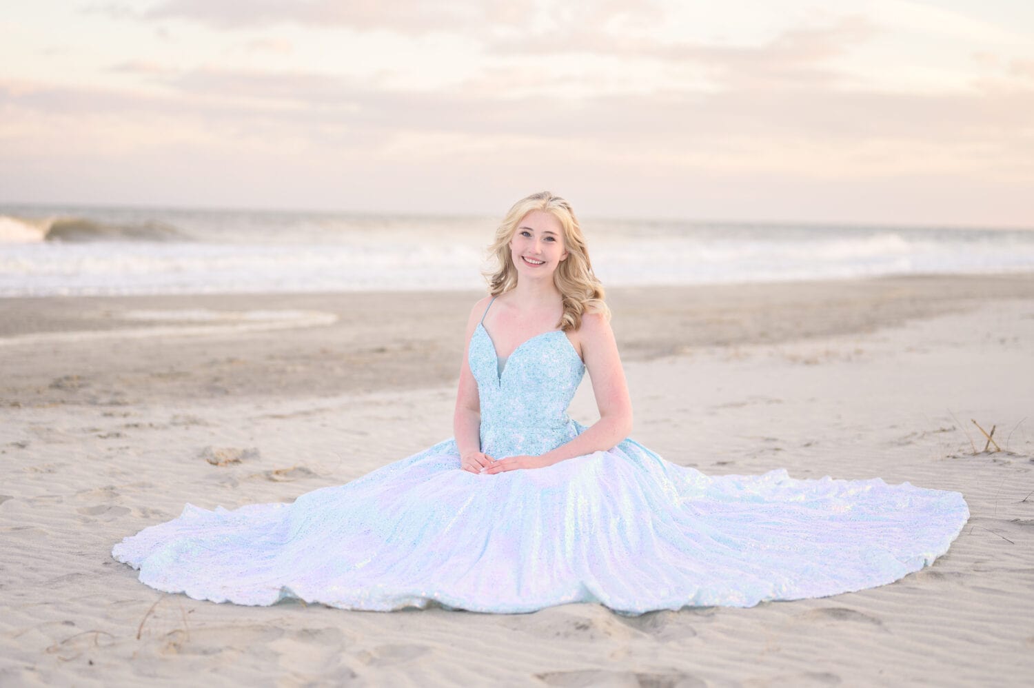 Girl sitting on the beach with her prom dress flowing around her - Huntington Beach State Park