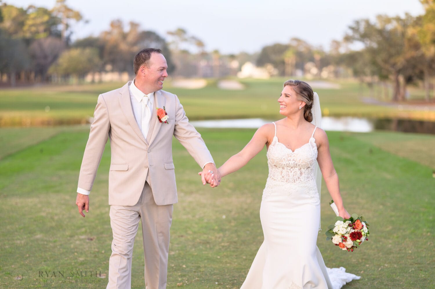 Holding hands smiling at each other - Dunes Golf & Beach Club