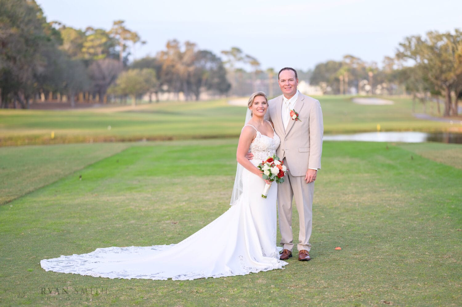 Portrait of bride and groom on the golf course - Dunes Golf & Beach Club