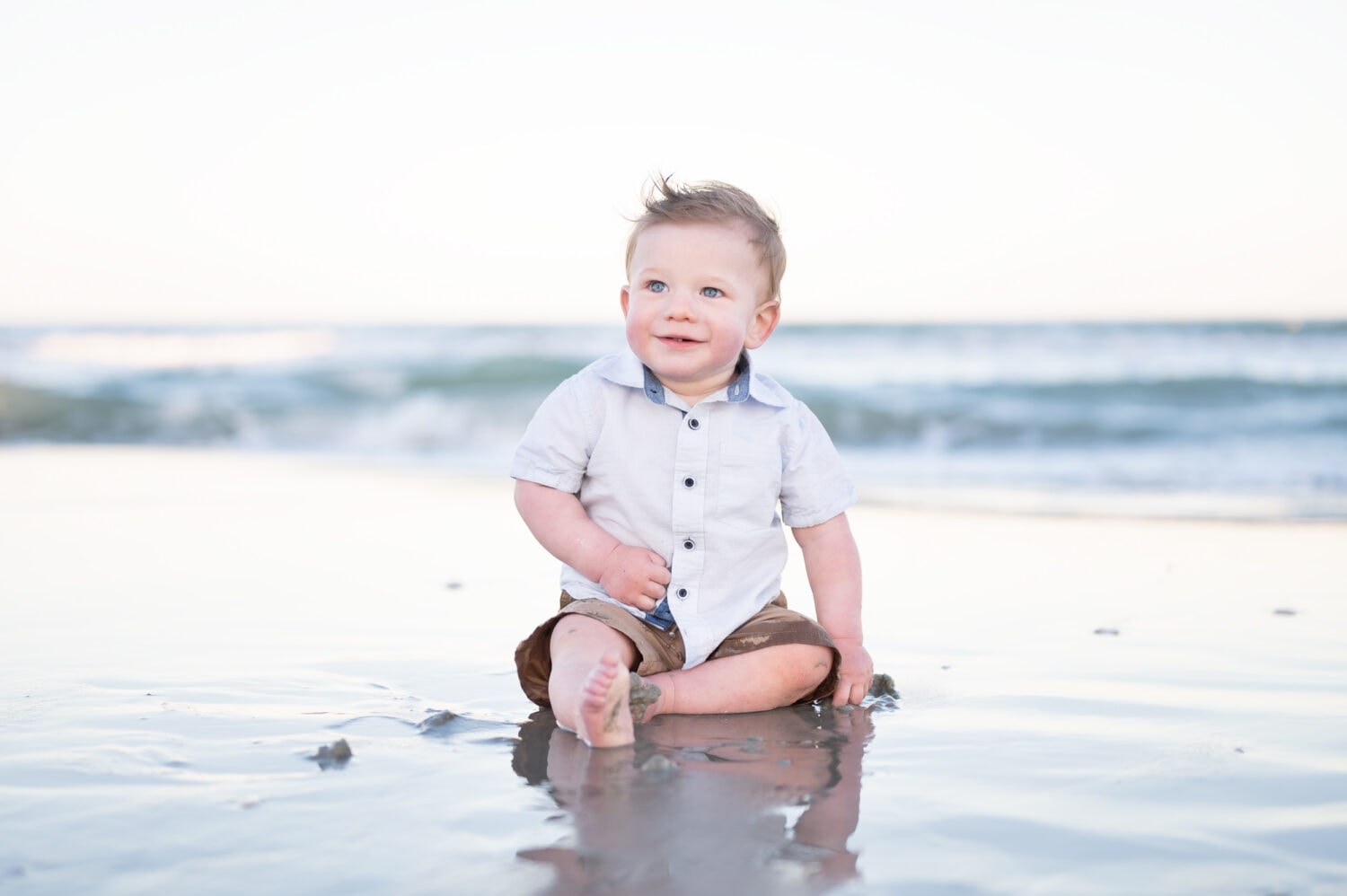 Baby boy sitting by the ocean - Garden City Beach