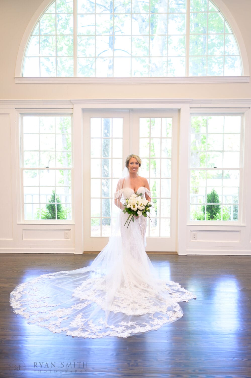 Bride standing in the window light  - The Village House at Litchfield