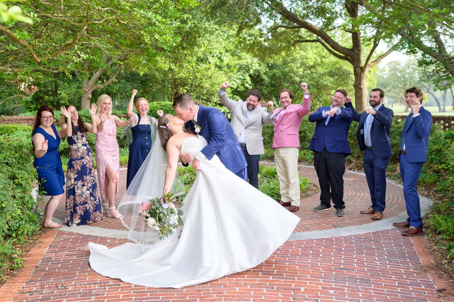 Dip back for a kiss with family cheering in the background - Pine Lakes Country Club