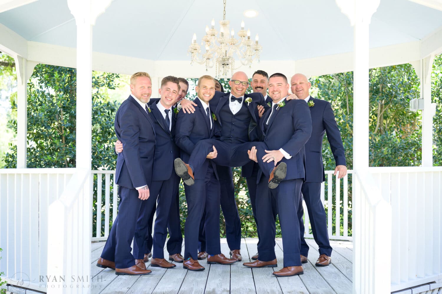 Groomsmen picking up the groom - The Village House at Litchfield