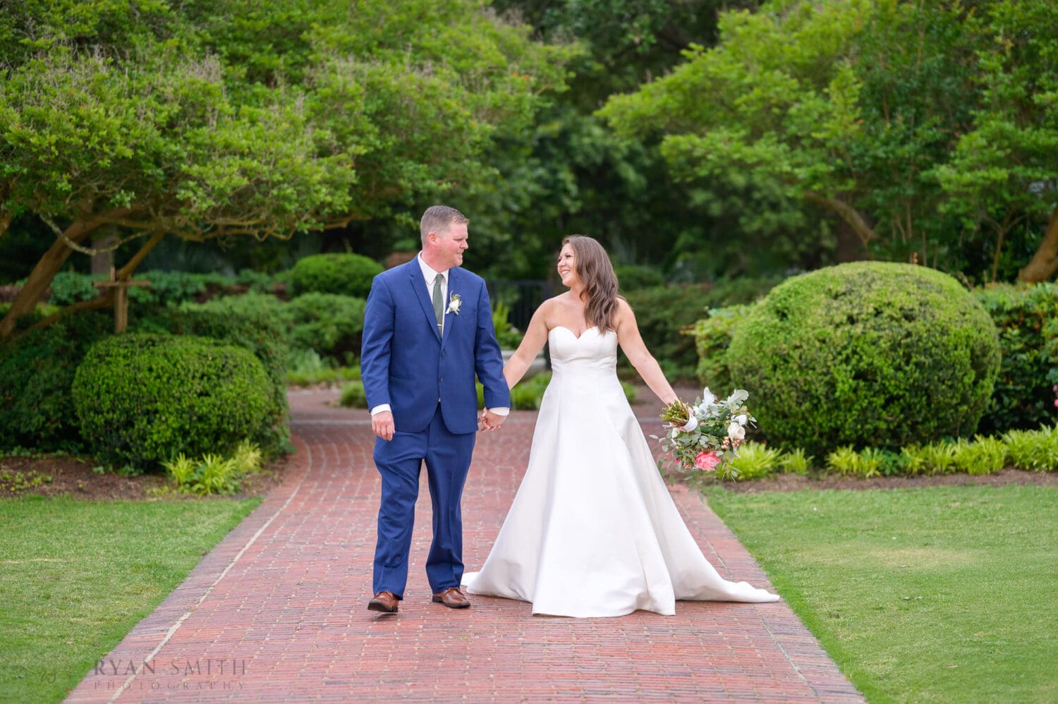 Happy couple holding hands - Pine Lakes Country Club