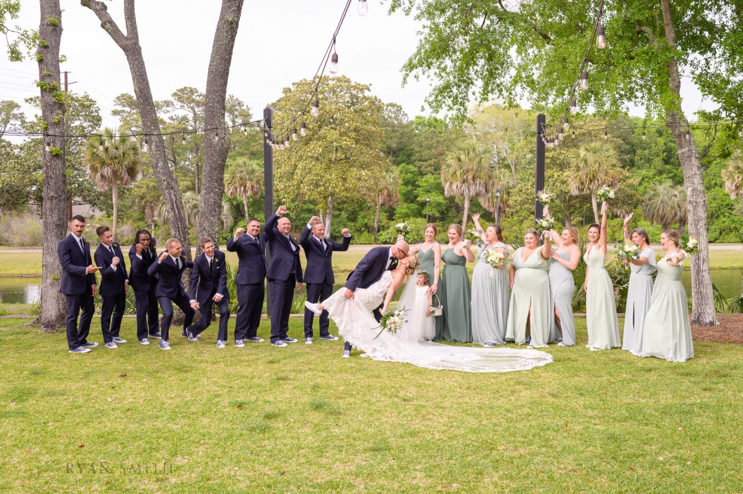 Kiss with the bridal party cheering - The Village House at Litchfield