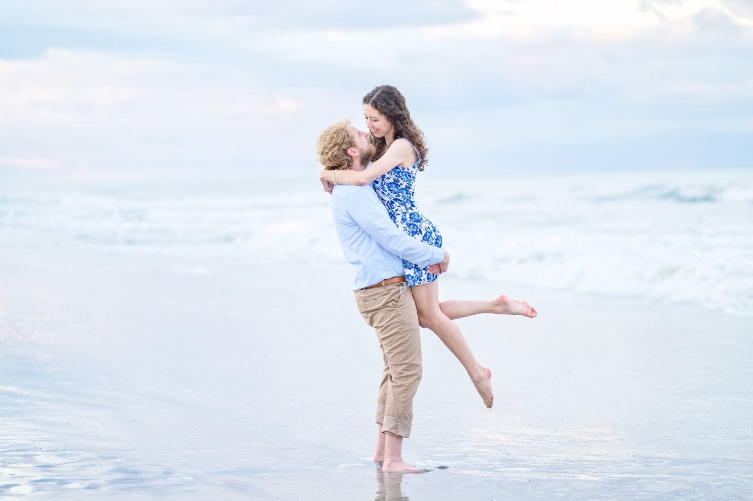 Lifting his fiance into the air by the ocean - Huntington Beach State Park