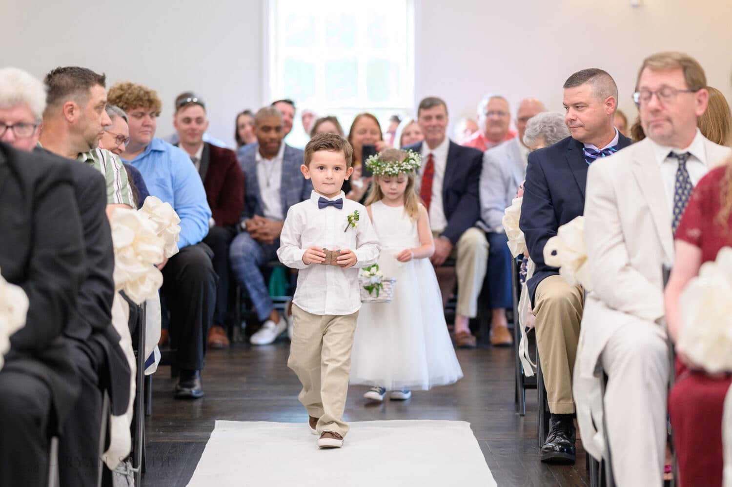 Ring bearer walking down the aisle - The Village House at Litchfield