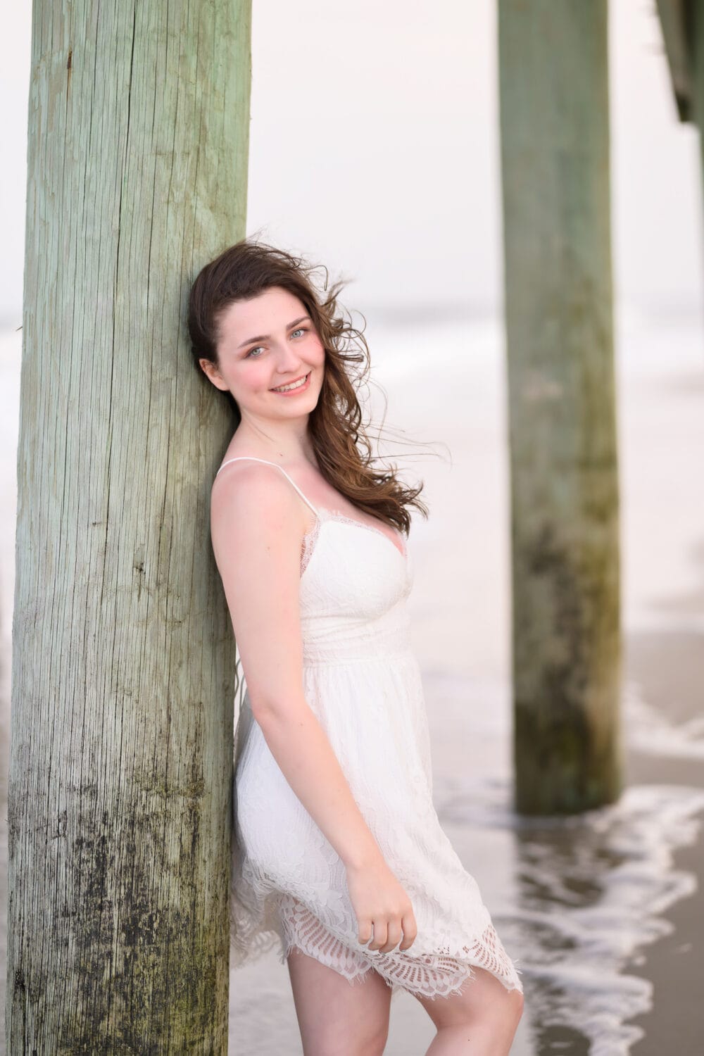 Senior leaning against the pier - Myrtle Beach State Park