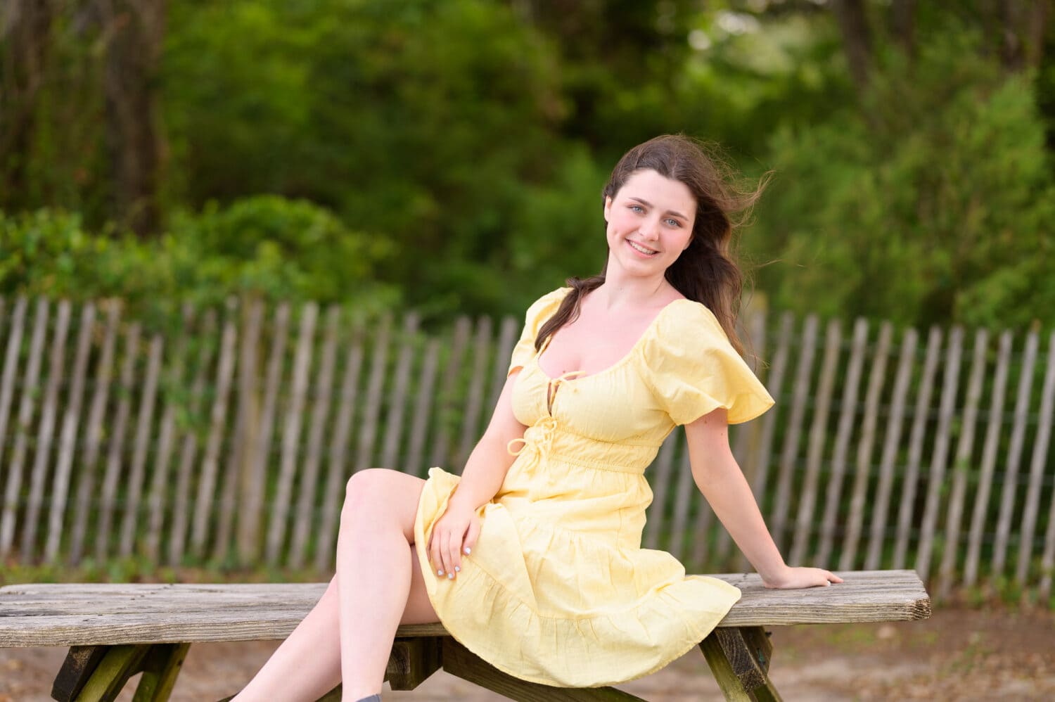 Senior portrait in yellow dress sitting on the picnic table - Myrtle Beach State Park