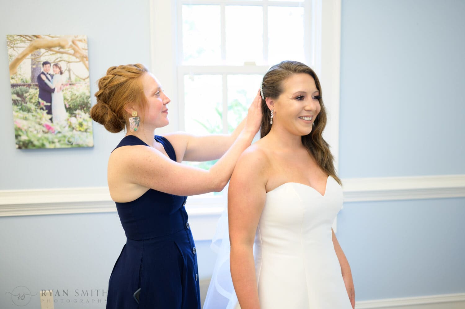 Sister helping bride with her hair - Pine Lakes Country Club