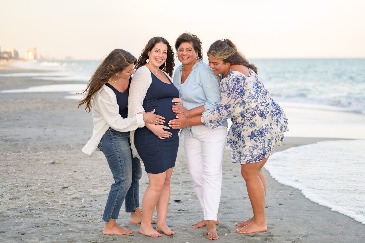 Sisters and mom touching her pregnant belly - Island Vista Resort