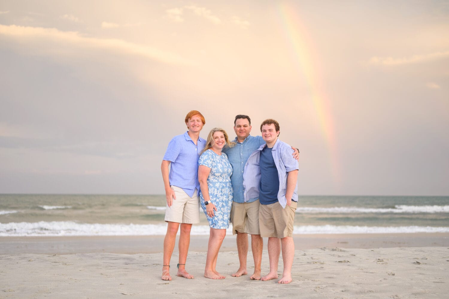 Family with a rainbow in the background - Huntington Beach State Park