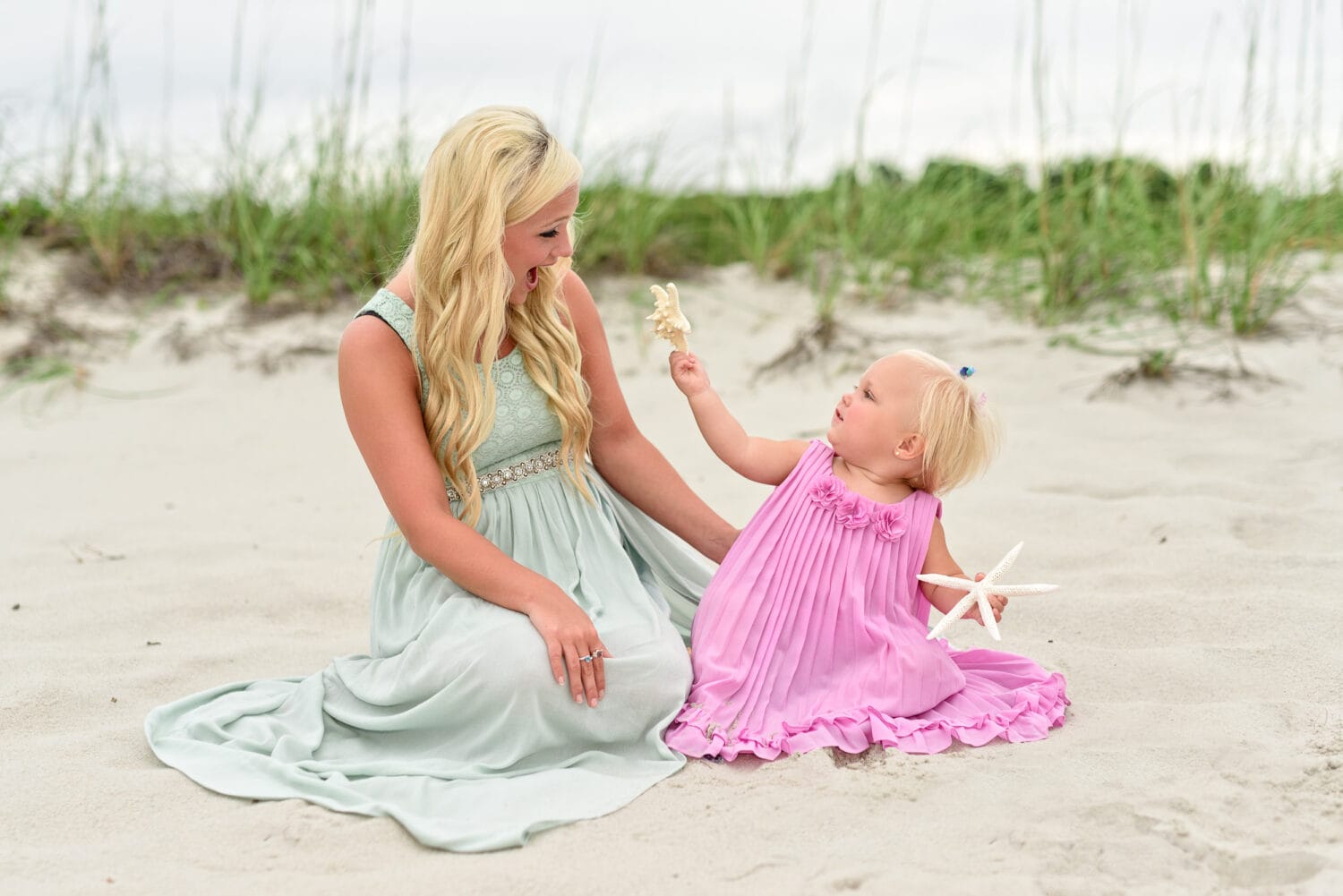 Baby girl showing mom her starfish - Myrtle Beach State Park