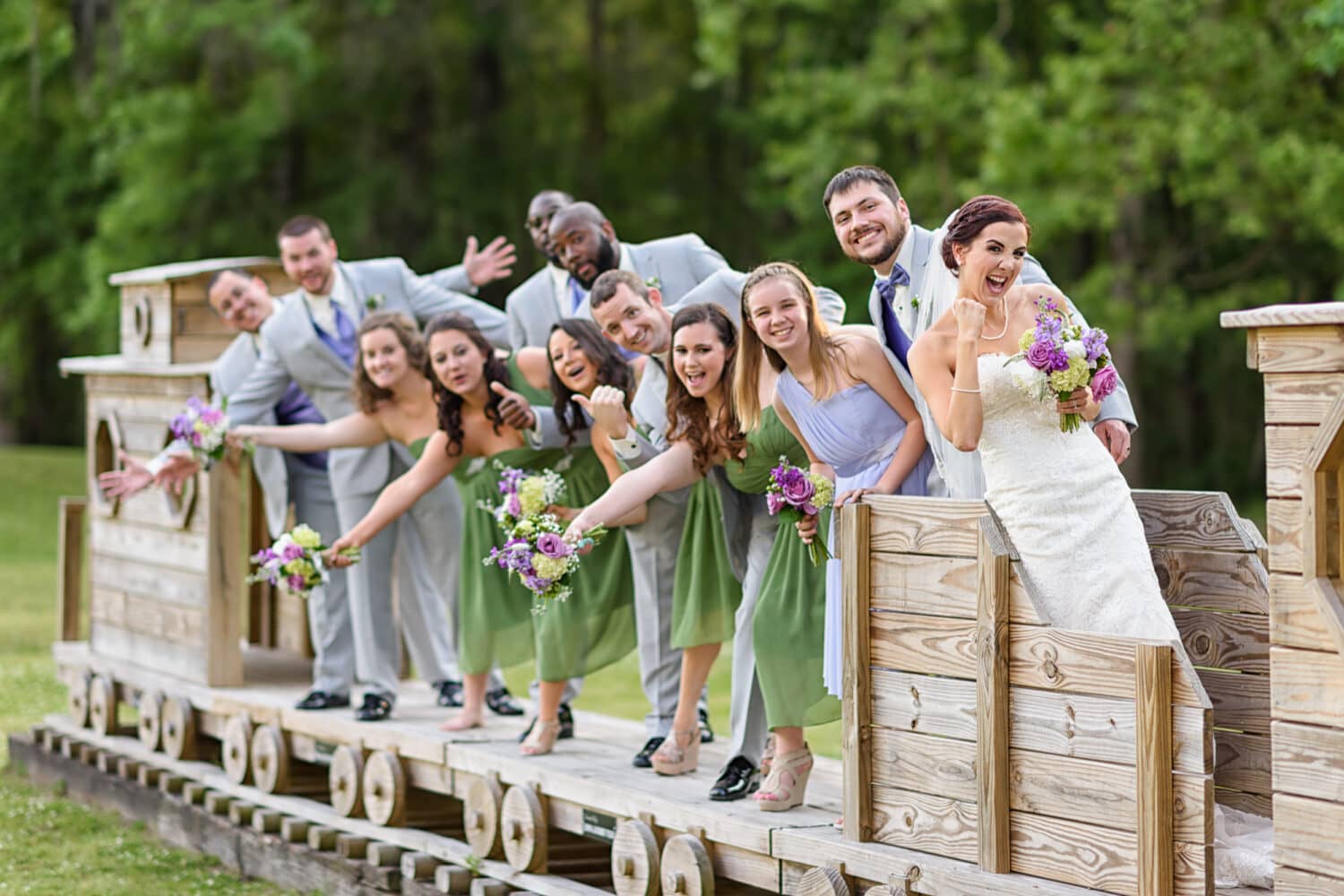 Bridal party having fun on the toy train - Upper Mill Plantation