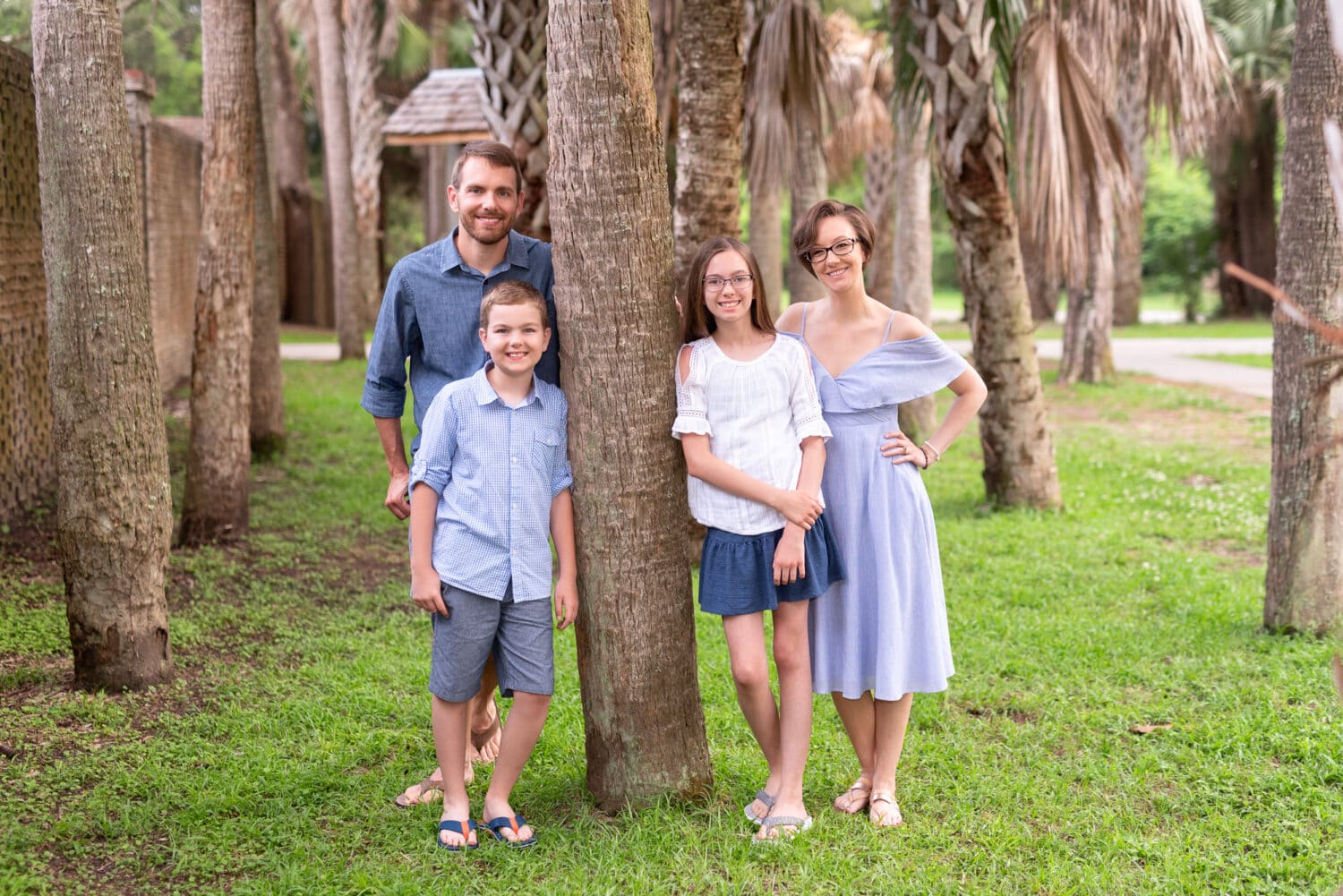 Cute family of 4 by the trees in front of the Atalaya Castle - Huntington Beach State Park