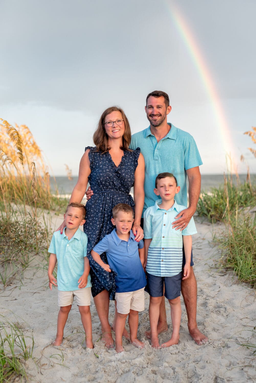 Family of 5 standing in front of a rainbow - Huntington Beach State Park