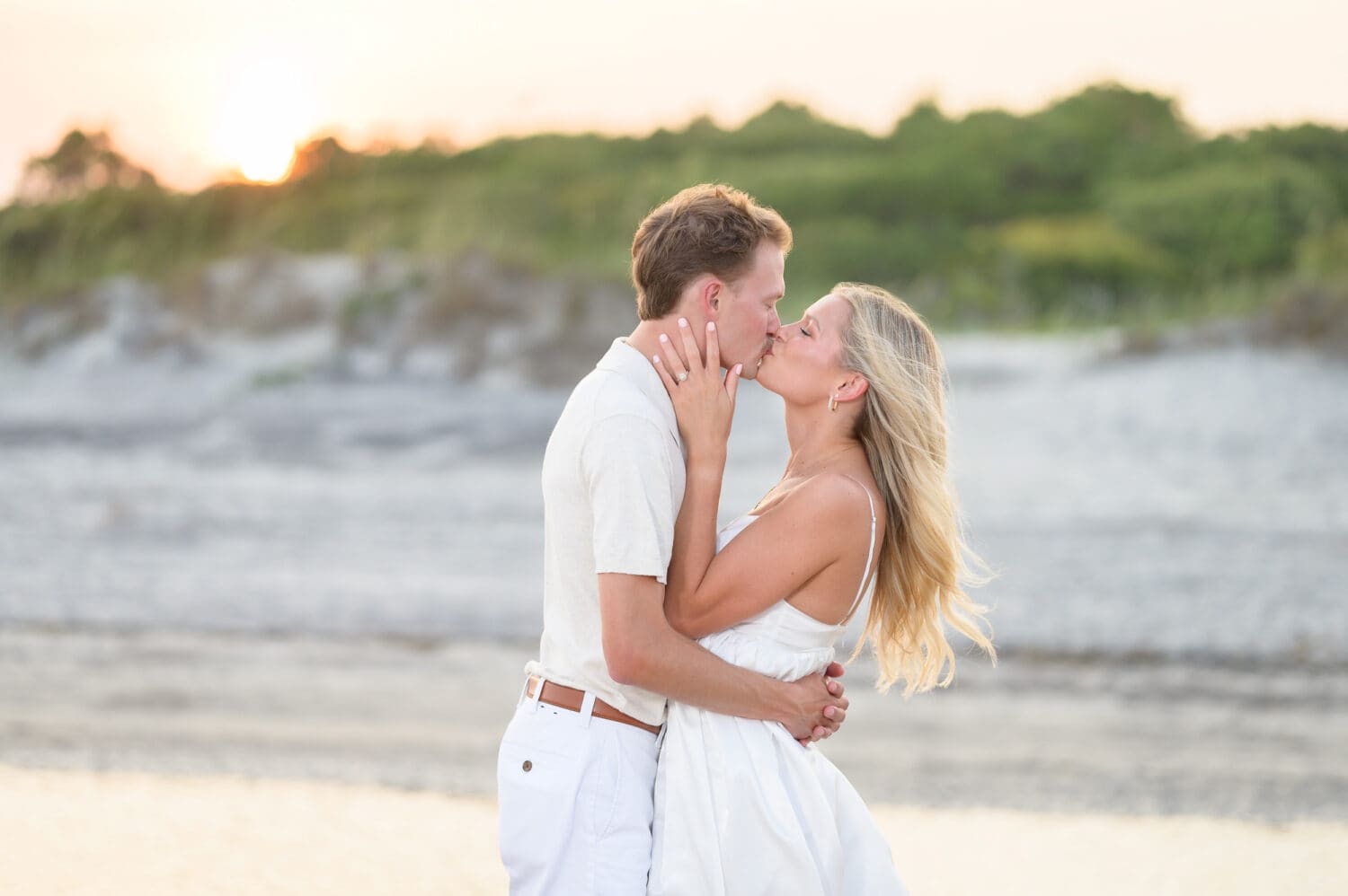 Kiss in front of the dunes at sunset - Huntington Beach State Park