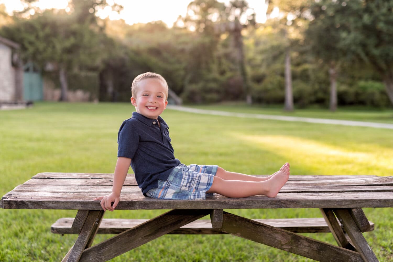 Little boy sitting on a picnic table in the sunset - Myrtle Beach