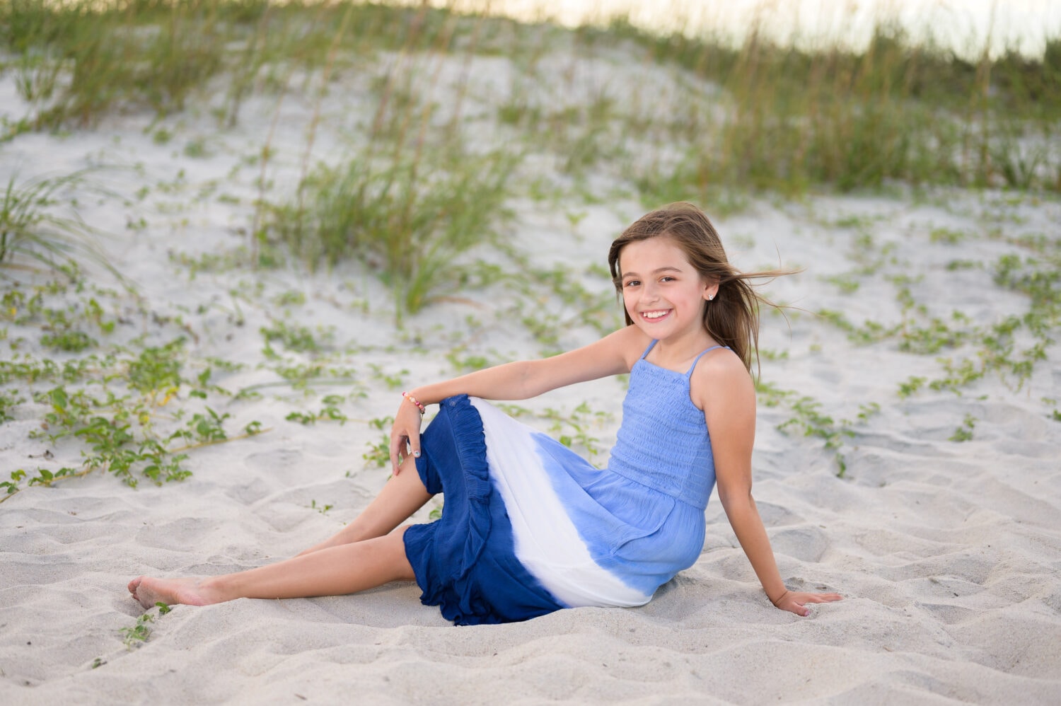 Little girl sitting by the dunes at sunset - Huntington Beach State Park
