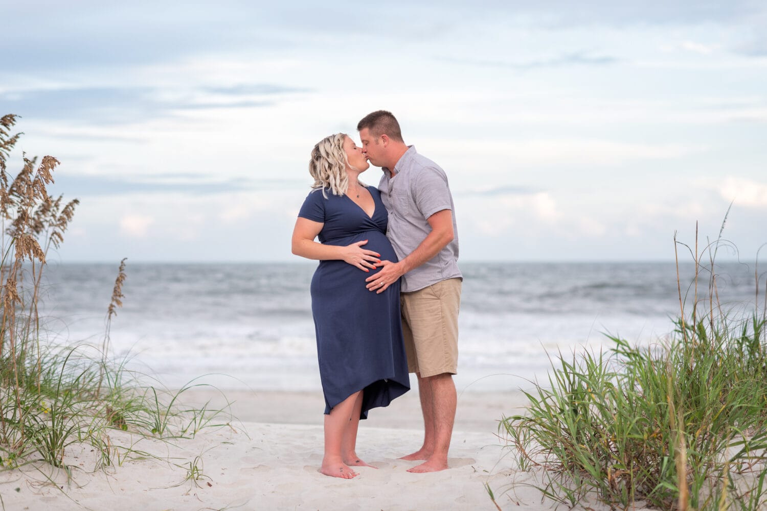 Maternity portrait kiss in front of the ocean - Huntington Beach State Park