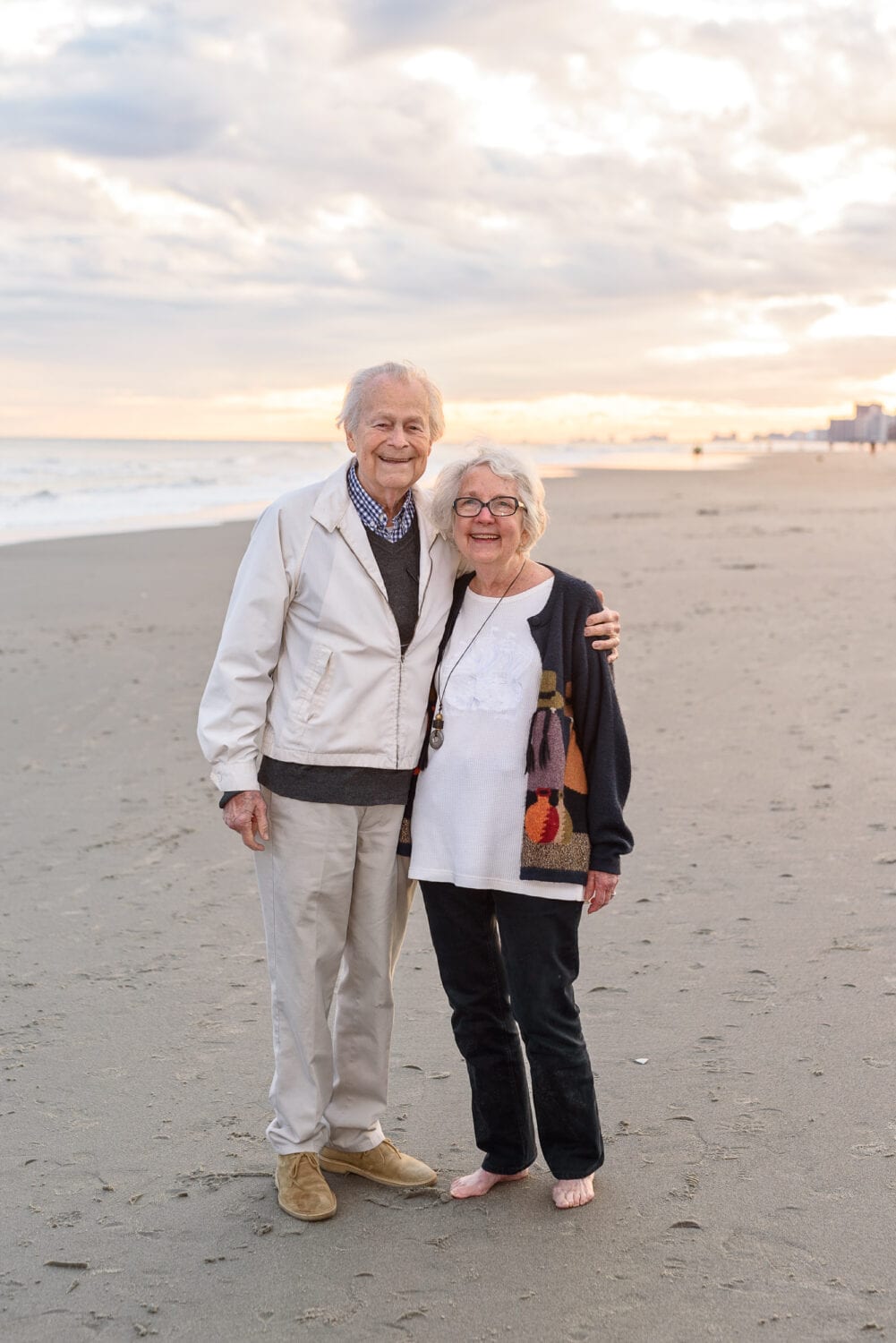 Older grandparents smiling together at sunset - North Beach Plantation