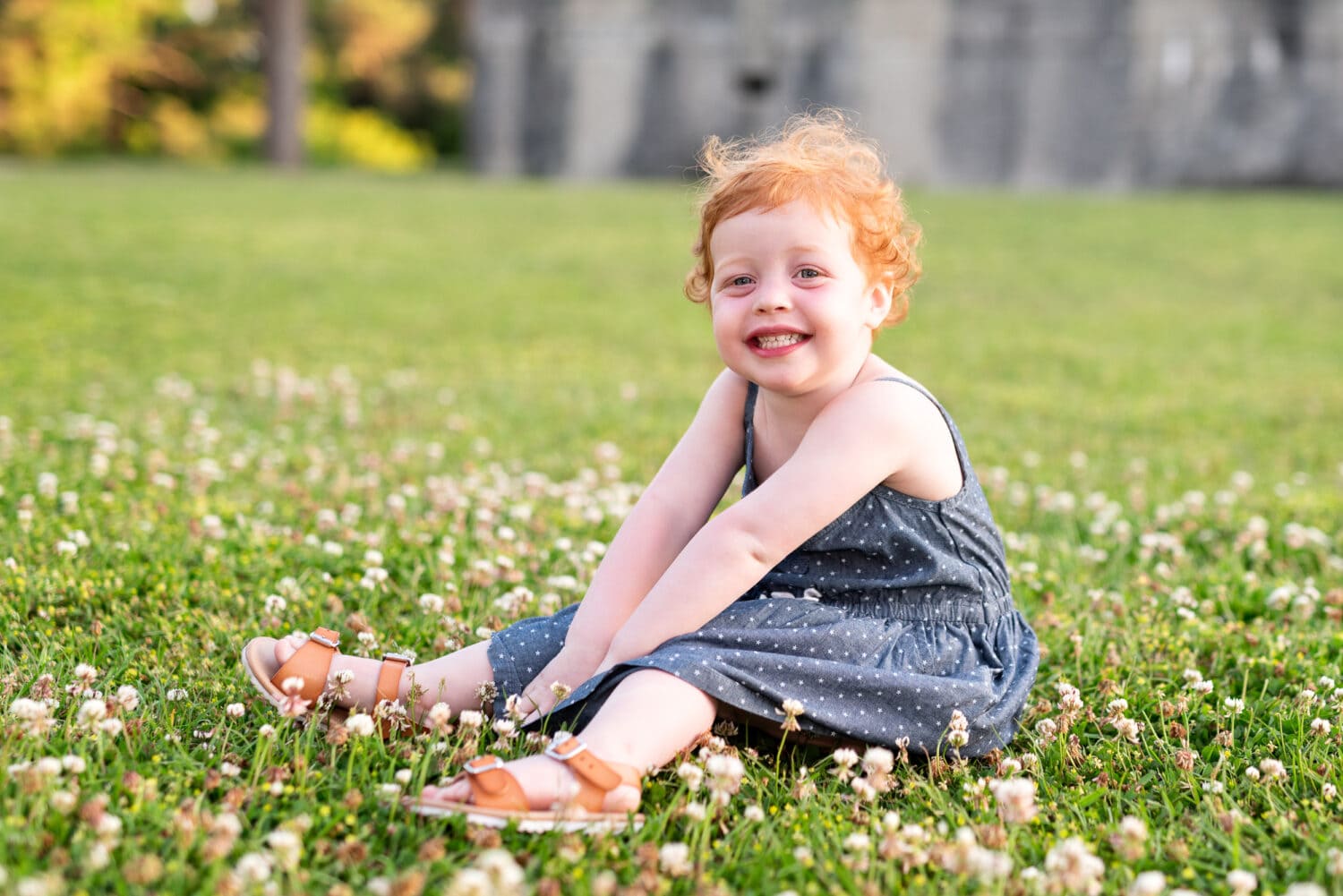 Redhead baby girl sitting in the grass - Atalaya Castle