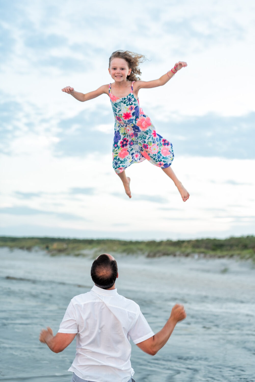 Some dads really take throwing the kids in the air seriously! - Huntington Beach State Park