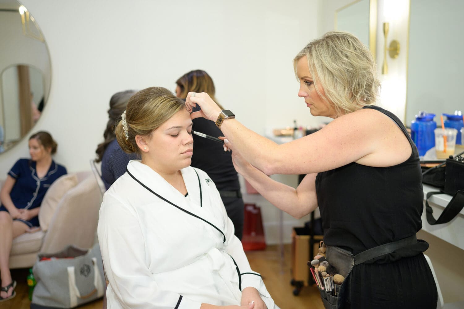 Bride getting makeup from The Blushing Bride - The Venue at White Oaks Farm